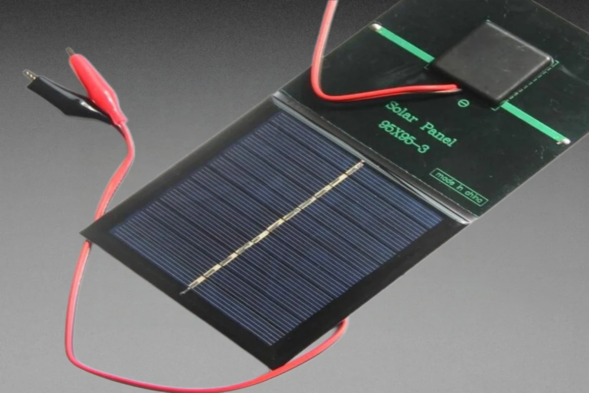 Mini solar panel with alligator clips for battery charging and maintenance